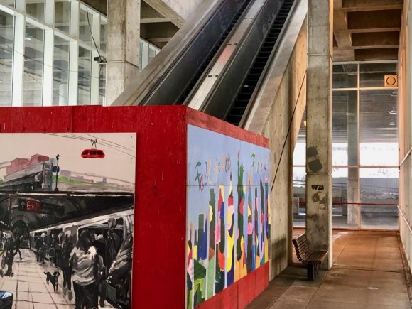We can do better than this: RIOC's Disgraceful Neglect of Motorgate Public Space A plywood shed, painted Roosevelt Island red, murals added, fails to hide a once useful escalator RIOC refuses to repair.